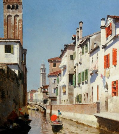 A bright scene of a gondola travelling down a canal carrying a lady with a red parasol. White houses are on either side with coloured window shutters and there is a bridge in the distance.