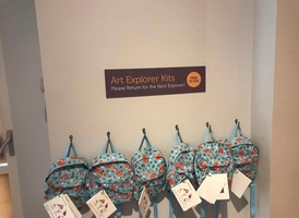 Art Explorer Kits near the Cooper Gallery lift. Blue backpacks with animals on and contents pages.