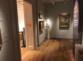 Cooper Gallery exhibits leading to the main entrance including veiled lady sculpture and art works in gold frames on the walls.