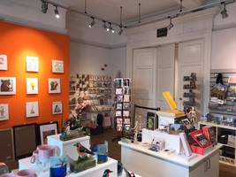 Cooper Gallery Gift Shop with items on sale such as postcards, print, coloured glass, books and tote bags.