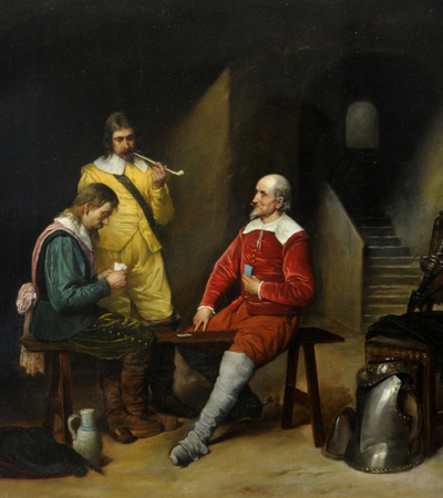 Oil painting of an interior scene with three male figures in seventeenth style costume. Two of the figures are seated and playing cards, the third is standing and smoking a clay pipe