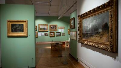 the entrance to the exhibition with paintings to the right and left and in front