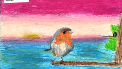 A colorful drawing of a bird on a branch against a vibrant sunset. The sky transitions from pink to orange, with a hint of the setting sun over a blue body of water. There is a patch of green leaves on the right side of the branch.